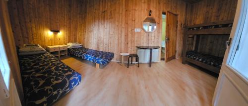 a bedroom with two beds and a wooden floor at Viitna Puhkekeskus in Viitna