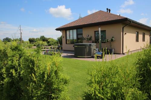 a house with a trash can in a yard at Lauras Apartment in Bauska