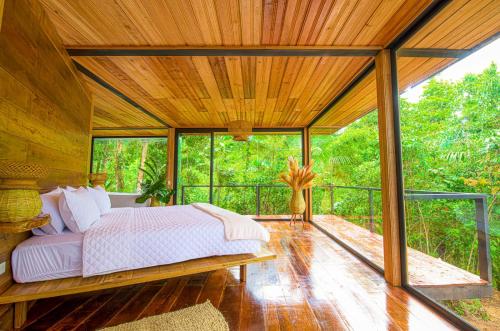 a bedroom with a large bed on a deck at Suite Alpayaku, Suite Boutique Privada con Desayuno Incluido, Cedro Amazon Lodge in Mera