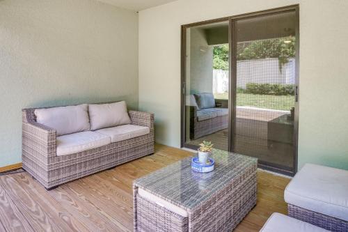 a living room with a couch and a table at Tavares Retreat with Covered Patio and Private Yard in Tavares