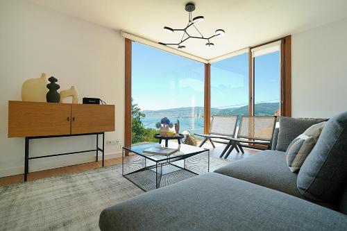 a living room with a couch and a table at GALIHOST - Casa Ría de Vigo in Redondela
