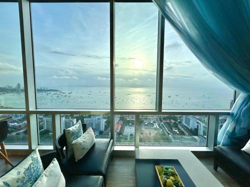 a living room with a view of the ocean at Centric Sunset Beach Residence in Pattaya