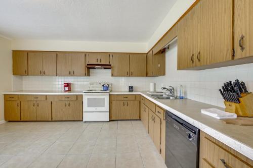 a kitchen with wooden cabinets and white appliances at Home 3 Mi to Homosassa Springs Wildlife State Park in Homosassa