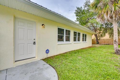 a yellow house with a white door and a yard at Home 3 Mi to Homosassa Springs Wildlife State Park in Homosassa