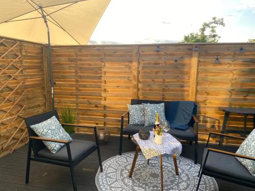 a patio with chairs and a table with an umbrella at Jannes Wohnung in Preetz