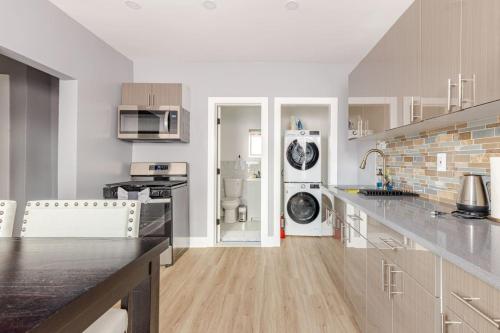 a kitchen with white appliances and a counter top at Modern 2 Bedroom in Black Rock in Bridgeport