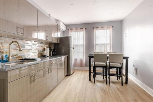 a kitchen with a table and chairs in it at Modern 2 Bedroom in Black Rock in Bridgeport