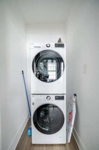 a washer and dryer in a corner of a room at 3 Bedrm Apt at Black Rock Suites in Bridgeport