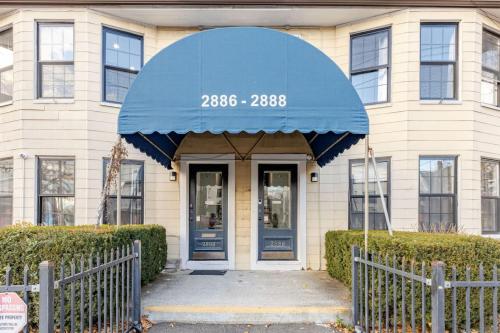 a building with a blue awning in front of it at Modern 2 Bedroom in Black Rock in Bridgeport