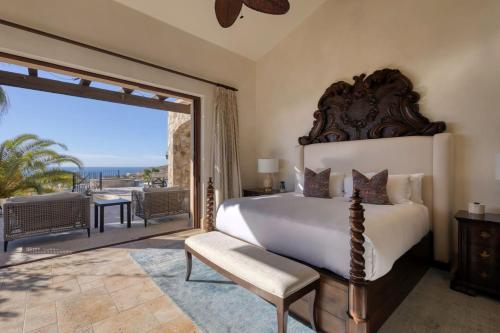 a bedroom with a large bed and a balcony at Ocean & Desert Hacienda Charm Villa in San José del Cabo
