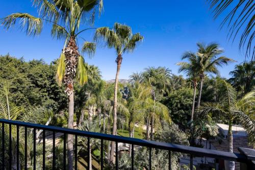 a view from the balcony of a resort with palm trees at Meditation Haven 1BR Pitahaya in San José del Cabo