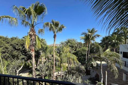 a view from the balcony of a resort with palm trees at Meditation Haven 1BR Pitahaya in San José del Cabo