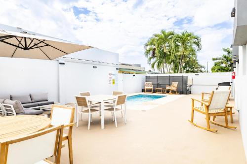 a patio with a table and chairs and a pool at 6 Bed 4 Bath Family Houses A8 w 2 Private Pools Dorado del Mar in Dorado