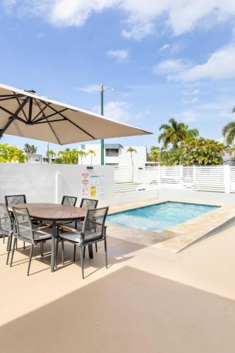a patio with a table and chairs and a pool at 6 Bed 4 Bath Family Houses A8 w 2 Private Pools Dorado del Mar in Dorado