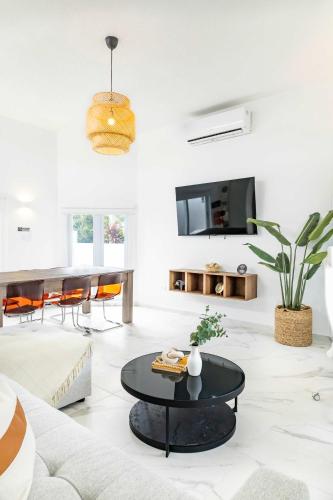 a living room with a couch and a table at 6 Bed 4 Bath Family Houses A8 w 2 Private Pools Dorado del Mar in Dorado