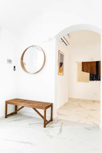 a room with a bench and a mirror at 6 Bed 4 Bath Family Houses A8 w 2 Private Pools Dorado del Mar in Dorado