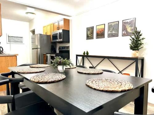 a black table with four pizzas on it in a kitchen at Pontiac Family-Friendly 3BR home in Pontiac