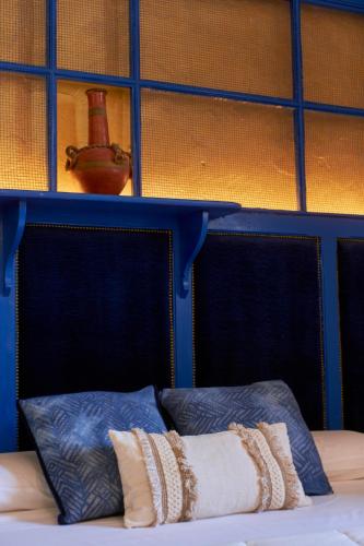 a bed with two pillows and a shelf above it at Castell Granadella in L'Ampolla