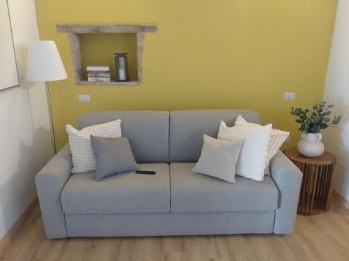 a couch with pillows on it in a living room at The house of Narnia in Narni