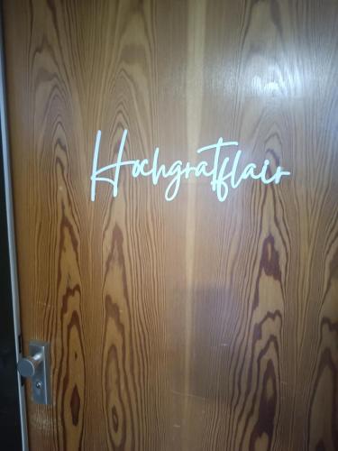 a sign on a wooden door with the word hacienda at Studio Apartment Hochgratflair in Oberstaufen