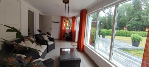 a living room with a couch and a window at Villa near the lake sauna boat big garden in Ryssby