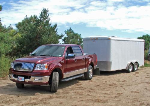 a red truck pulling a trailer with a camper at Hampton Inn & Suites Newport/Cincinnati, KY in Newport