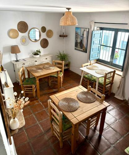 a dining room with tables and chairs in a room at Casa Maroma in Cómpeta