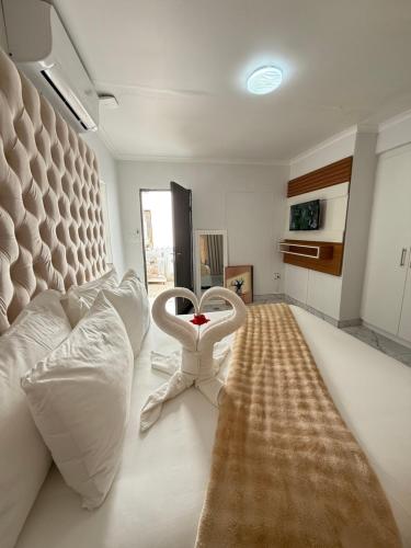 a living room with a white couch and a table at Malrose guesthouse Windhoek in Windhoek