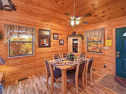 a dining room with a table and chairs in a cabin at Mountain Memories Holiday home in Gatlinburg
