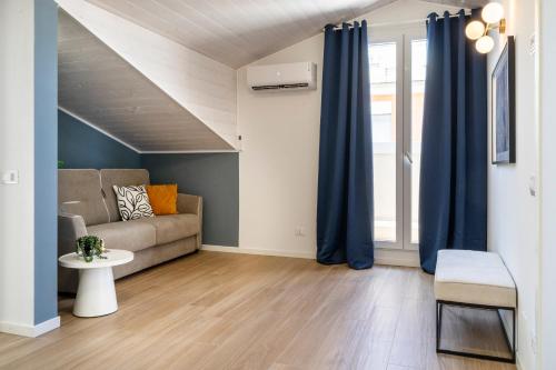 a living room with blue curtains and a couch at Civita Living in Civitanova Marche