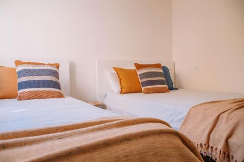 two beds sitting next to each other in a room at Just Like Home - Casa Lima in Caminha
