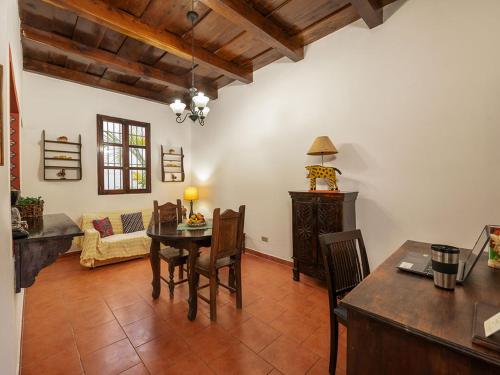 a living room with a table and chairs and a couch at Apartamentos Antigua in Antigua Guatemala