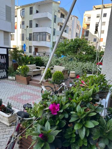 a bike parked next to a bunch of plants at Vila Zhiti in Durrës