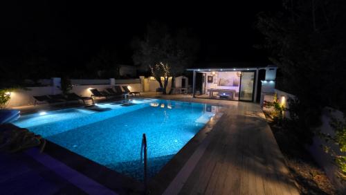 a swimming pool in a yard at night at Villa Galaxy in Dalyan