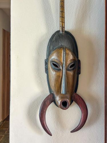 a mask with tentacles attached to a wall at Apartment Sunkiss in Almirida