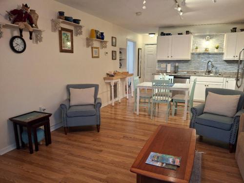 a living room with a table and chairs and a kitchen at The Three Sisters - Pelican Crystal River FL in Crystal River