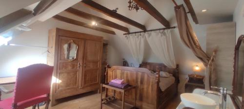 a bedroom with a bed and a cabinet and a sink at Le Moulin de Benechou in Olemps