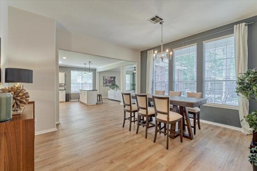 a dining room and living room with a table and chairs at Woodlands Grand 3BR Cozy House in The Woodlands