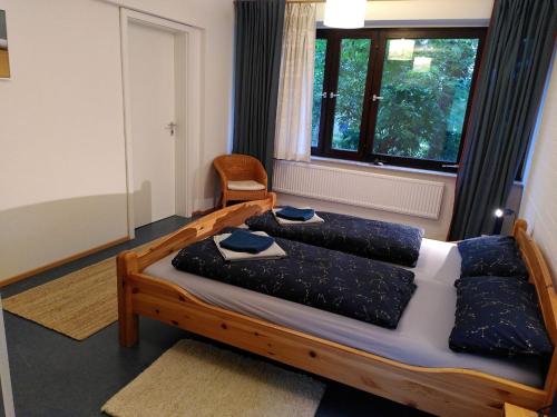 a bedroom with two beds and a window at Gästehaus am Sternberg in Gomadingen