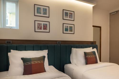 Ένα ή περισσότερα κρεβάτια σε δωμάτιο στο SOVA Hotel Bangkok