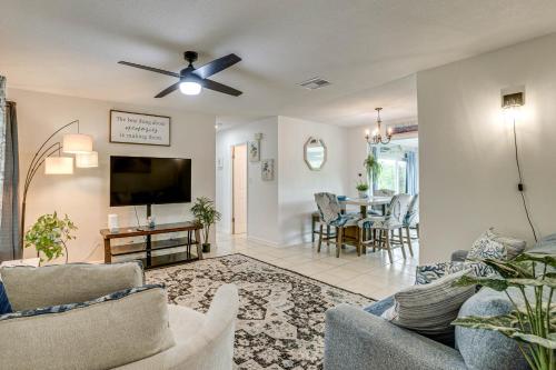 a living room with a couch and a ceiling fan at Port Charlotte Home with Sunroom, Grill and Fire Pit! in Port Charlotte