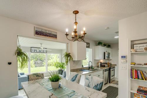 a kitchen and dining room with a dining table at Port Charlotte Home with Sunroom, Grill and Fire Pit! in Port Charlotte