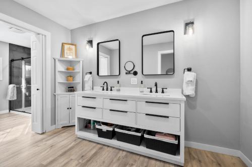 a bathroom with a white sink and two mirrors at Tumalo Ranch home in Tumalo