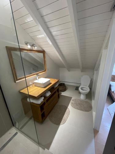 a bathroom with a sink and a toilet at L'abri Côtier - Appartement duplex 2 chambres in Le Gosier