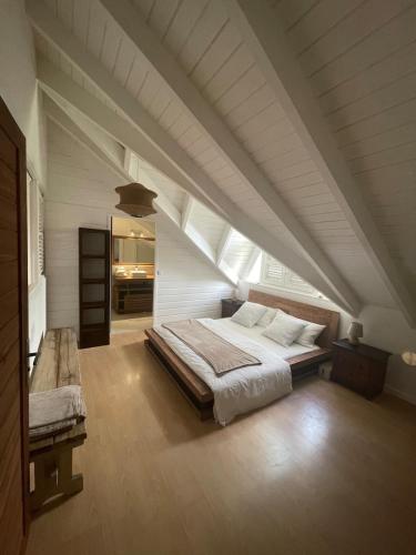 a bedroom with a large bed in an attic at L'abri Côtier - Appartement duplex 2 chambres in Le Gosier