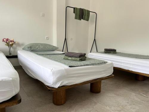 two twin beds in a room with towels on them at Odisej House Tolmin in Tolmin