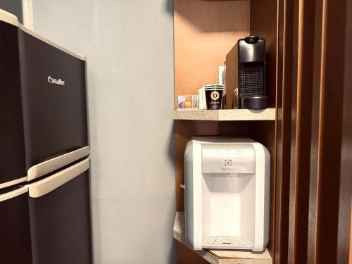 a hotel room with a drink dispenser on a wall at 806 - Rentaqui - Flat Studio Bela Cintra Elegance - Consolação in Sao Paulo