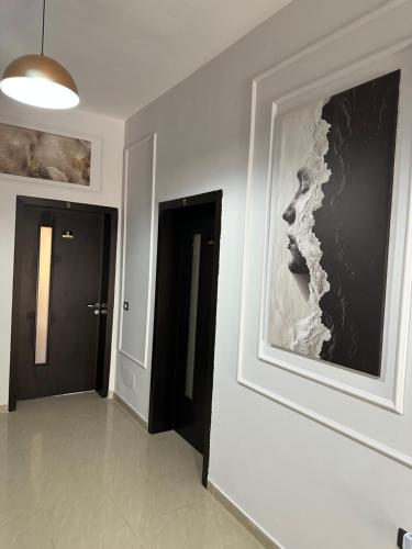 a hallway with a picture of a woman on a wall at Vila Zhiti in Durrës