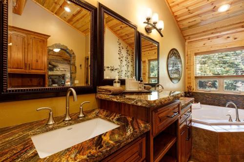 a bathroom with a large sink and a tub at Great Escape Retreat Hot Tub Fire Pit in Duck Creek Village