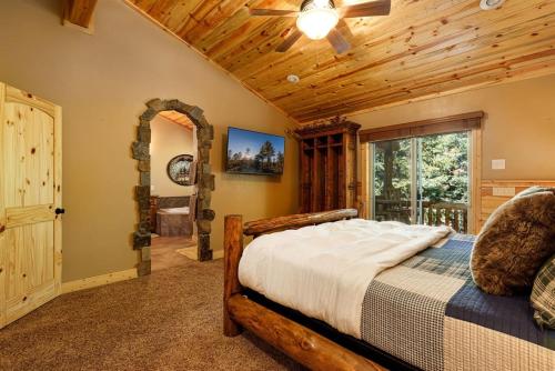 a bedroom with a bed and a wooden ceiling at Great Escape Retreat Hot Tub Fire Pit in Duck Creek Village